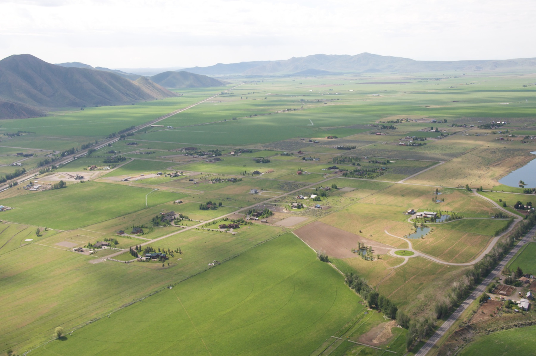 Open valley terrain with visible water, slope, and surrounding landform structure.