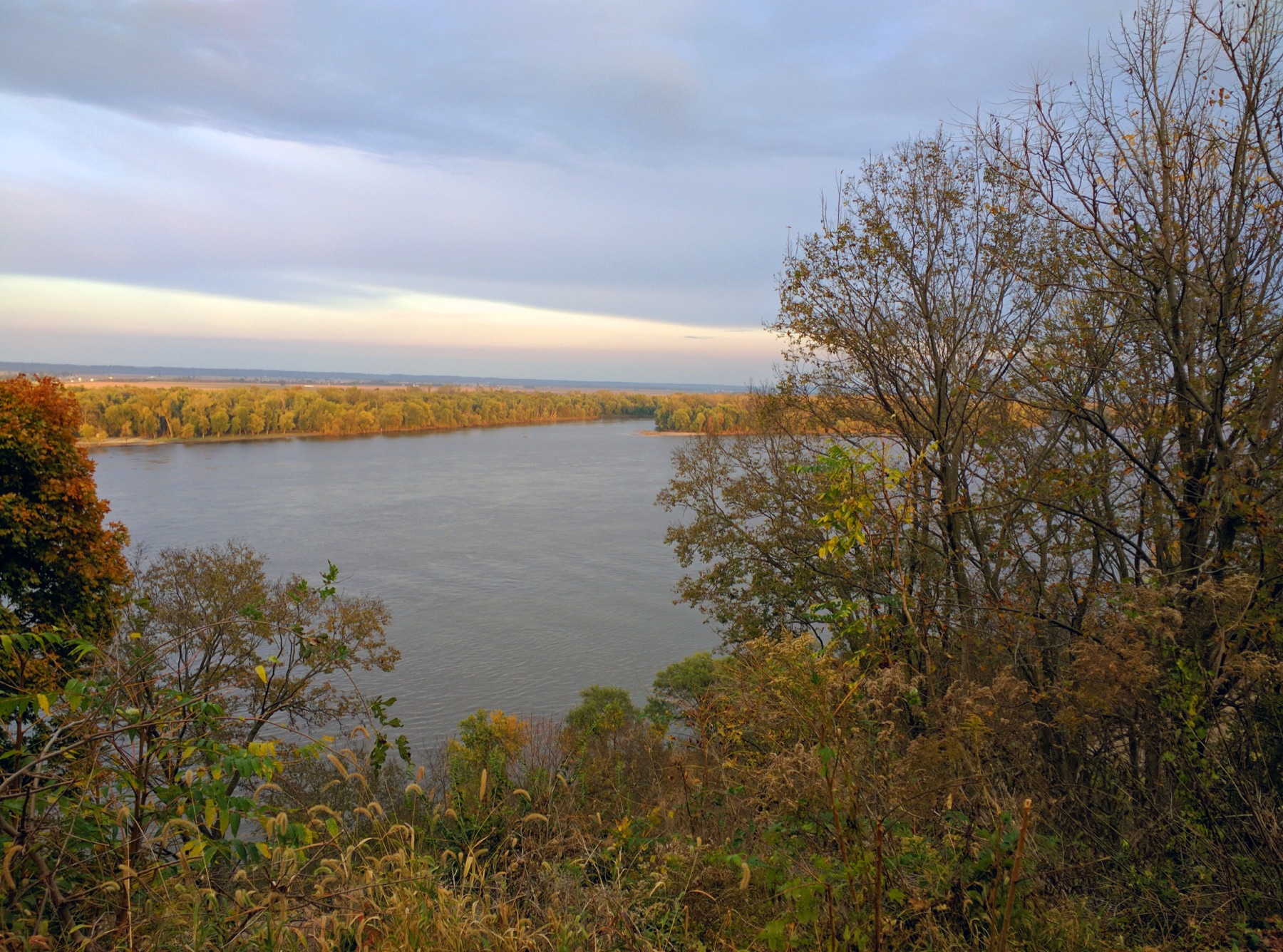 Aerial river bend with surrounding floodplain and terrain context.